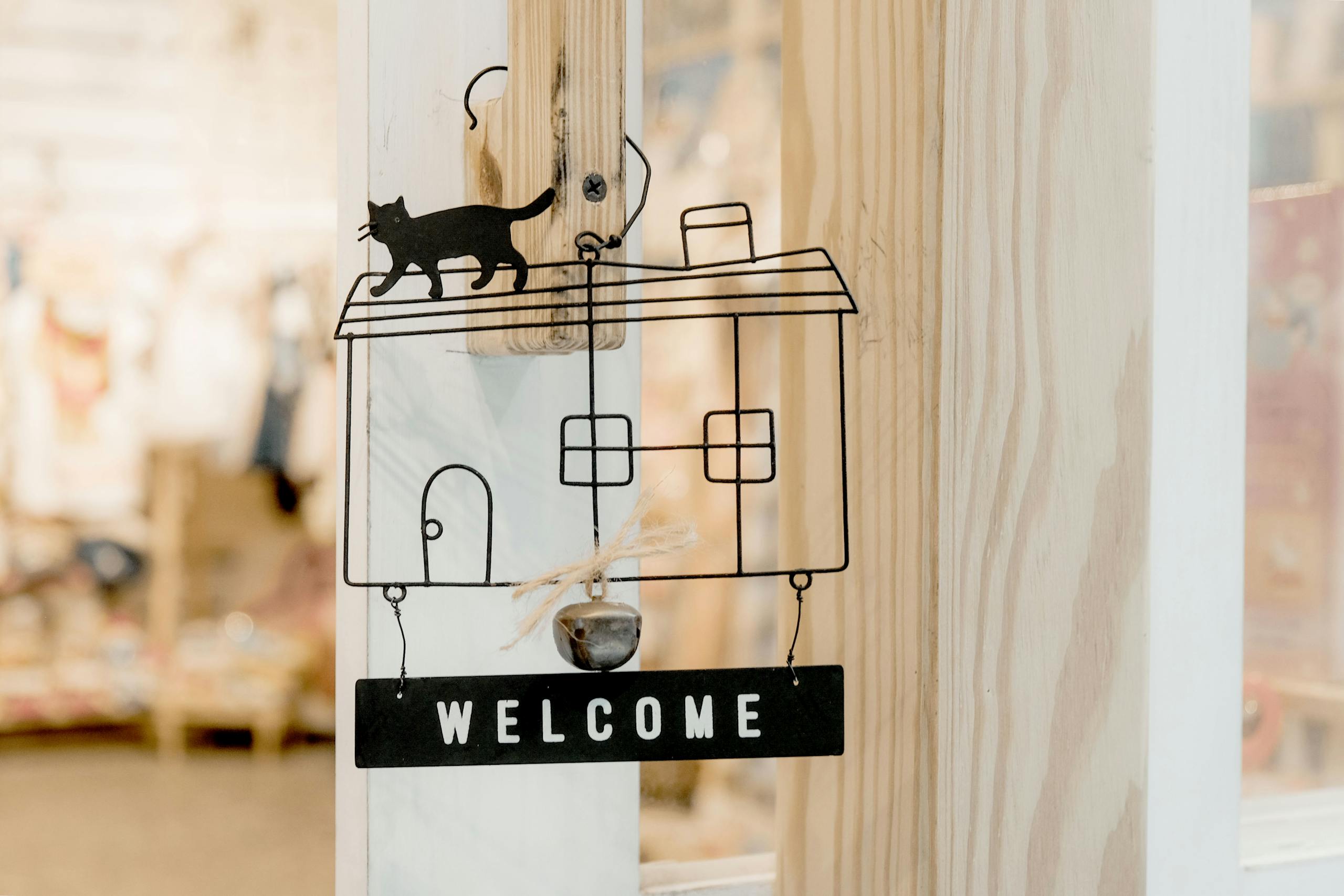 Interior design wooden door decoration featuring a welcome sign with cat silhouette.